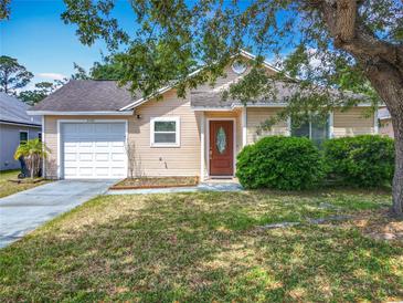 Charming single-story home with well-maintained lawn, front shrubs, and a one car garage at 3120 Ginger Cir, Orlando, FL 32826