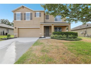 Charming two-story home featuring a two-car garage, neutral paint, manicured landscaping, and a welcoming front porch at 3443 Berkshire Woods Ter, Deltona, FL 32725