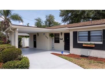 Charming front exterior with a covered parking area and meticulously landscaped surroundings at 4015 Kirkland Blvd, Orlando, FL 32811