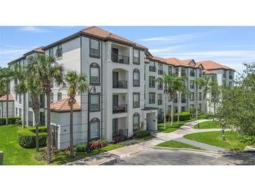 Attractive condominium building with private balconies, tile roof and tropical landscaping at 4024 Breakview Dr # 40604, Orlando, FL 32819