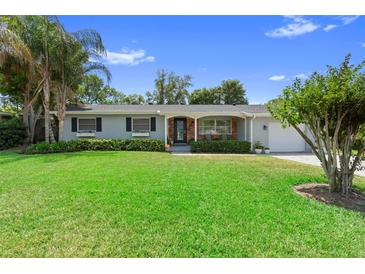 Charming single-story home with well-manicured lawn, tidy hedges, and a welcoming entrance at 4700 Larado Pl, Orlando, FL 32812