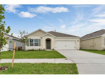 Charming single-story home with a well-manicured lawn and attached two-car garage at 536 Talisi Loop, St Cloud, FL 34771