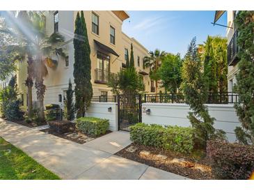 Elegant townhouse with manicured landscaping, gated entry, and modern architectural details at 654 Mariposa St, Orlando, FL 32801