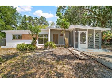 Charming single-story home featuring a screened porch and partially landscaped front yard at 819 Edgewater Dr, Eustis, FL 32726