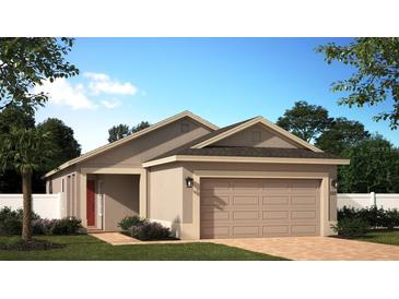 Charming single-story home with a two-car garage, brick walkway, and well-manicured landscaping at 876 Scrub Oak Hammock Rd, Davenport, FL 33837