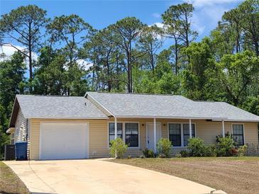 Charming single-story home with a well-maintained lawn and attached garage at 1472 6Th Ave, Deland, FL 32724