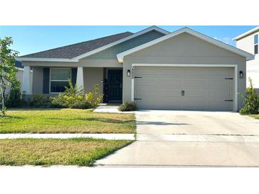 Charming single-Gathering home featuring a two-car garage and well-maintained lawn at 2000 Golden Beak Dr, Eagle Lake, FL 33839