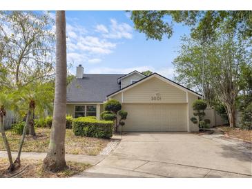 Charming two-story home featuring a well-maintained lawn and an attached two-car garage at 3001 Little Cypress Cv, Winter Park, FL 32792