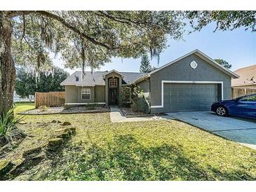 Charming single-Gathering home showcasing well-maintained landscaping and a two-car garage at 4012 King Edward Dr, Orlando, FL 32826