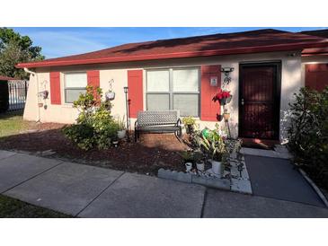 Charming single-story home featuring a cozy front bench, red shutters, and well-maintained landscaping at 68 S Marbrisa Way, Kissimmee, FL 34743