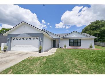 Charming single-story home boasting a well-maintained lawn and a two-car garage at 119 Ridgecrest Dr, Eustis, FL 32726