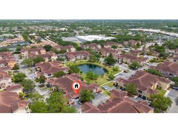 Wonderful aerial view of condo community with beautiful landscaping and central pond at 12107 Poppy Field Ln # 105, Orlando, FL 32837