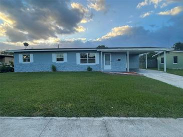 Charming single-story home featuring a covered carport and well-maintained front lawn at 1414 Park Manor Dr, Orlando, FL 32825