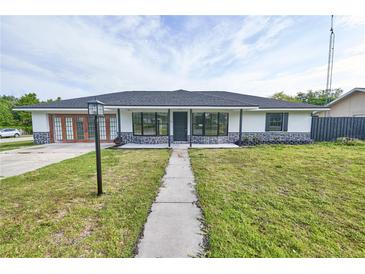 Charming single-story home featuring a landscaped front yard and a welcoming entrance with decorative stone accents at 211 Marion Oaks Ln, Ocala, FL 34473