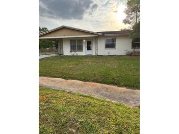 Charming single-story home featuring a well-maintained front yard and covered parking at 3040 Pinder Ct, Orlando, FL 32811