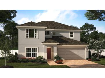 Charming two-story home boasts a brick driveway, attached two-car garage, and beautifully landscaped front yard at 4213 Deleon St, Haines City, FL 33844