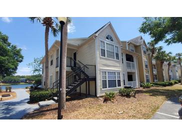A beautiful condo building with well maintained grounds, landscaping, and stairway at 1071 S Hiawassee Rd # 1211, Orlando, FL 32835