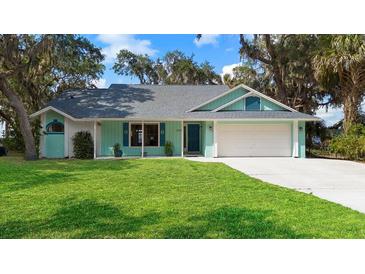 Charming home featuring a lush lawn, freshly-painted trim, and an attached two-car garage at 3385 Lake Harney Cir, Geneva, FL 32732