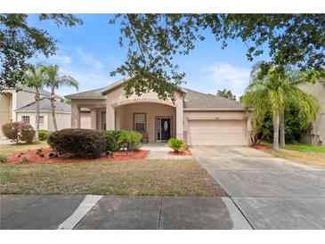Charming single-story home featuring a manicured lawn and a two-car garage at 5126 Rishley Run Way, Mount Dora, FL 32757