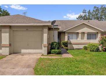 Charming single-story home featuring a one-car garage and well-maintained front lawn at 543 Azinger Cir, Orlando, FL 32824