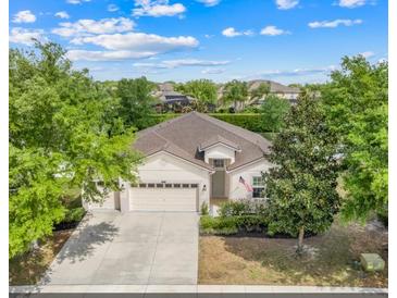 Beautiful single-story home featuring a three-car garage and a well-manicured lawn with mature trees at 5839 Tarleton Way, Mount Dora, FL 32757
