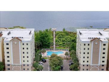 Aerial view of complex featuring beautiful pool, private pier, and parking at 6336 Buford St # 307, Orlando, FL 32835