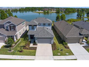 Stunning aerial view of home, showcasing its well-manicured lawn and waterfront location at 6728 Great Bear Dr, Lakeland, FL 33805