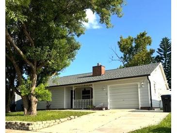 Charming single-story home featuring a well-maintained lawn, attached garage, and inviting curb appeal at 7540 Govern Blvd, Orlando, FL 32822