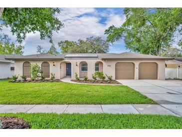 Charming home featuring a well-maintained lawn, a two car garage, and enhanced curb appeal at 1005 Turkey Hollow Cir, Winter Springs, FL 32708