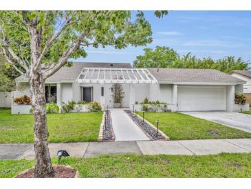 Charming single-story home with a well-manicured lawn and inviting walkway at 1218 Fairway Dr, Winter Park, FL 32792