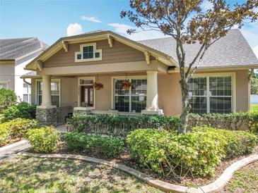 Charming single-Gathering home featuring a cozy front porch, well-manicured landscaping, and inviting curb appeal at 12724 Bideford Ave, Windermere, FL 34786