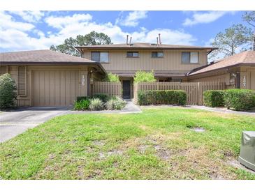 Charming townhome featuring well-kept lawn, updated paint, and fenced-in courtyard at 135 Heron Bay Cir, Lake Mary, FL 32746