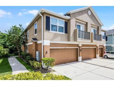 Two-story townhome with a two-car garage, balcony, and well-maintained landscaping at 1821 San Jacinto Cir, Sanford, FL 32771