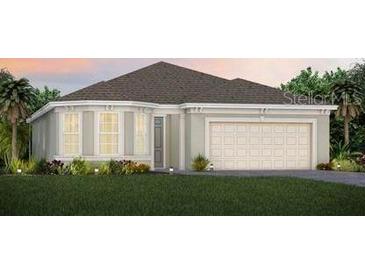 Charming single-story home with a symmetrical facade, a manicured lawn, and an attached two-car garage at 2745 Serenity Meadow Dr, Kissimmee, FL 34744