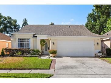 Charming one-story home featuring a manicured lawn and a two-car garage at 342 Hanging Moss Cir, Lake Mary, FL 32746