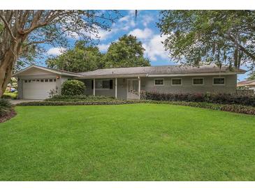 Charming single-story home with mature trees and a well-manicured lawn at 3605 Pershing Ave, Orlando, FL 32812