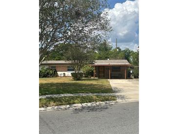 Charming single-story home featuring a well-maintained lawn and mature trees for added curb appeal at 5811 Harcourt Ave, Orlando, FL 32839