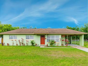 Charming single-story home with a well-manicured lawn and beautiful landscaping at 604 S Oxalis Ave, Orlando, FL 32807