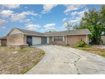 Charming single-story brick home with attached garage and curved driveway at 1030 Blue Horizon Dr, Deltona, FL 32725