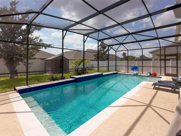 Gorgeous screened-in pool with sparkling water and sun loungers on the patio, perfect for relaxation and entertaining at 1706 Leatherback Ln, St Cloud, FL 34771