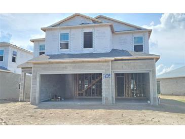 Under construction two-story home with a two-car garage awaiting completion details at 2630 Great Heron Ave, St Cloud, FL 34773