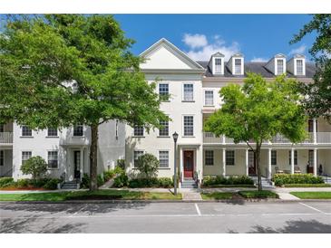 Charming townhome with beautiful curb appeal, featuring lush green trees and well-maintained landscaping at 4725 Anson Ln, Orlando, FL 32814