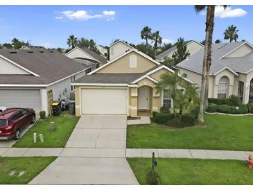 Charming single-Gathering home featuring a two-car garage, landscaped yard, and welcoming front porch at 833 Lockbreeze Dr, Davenport, FL 33897