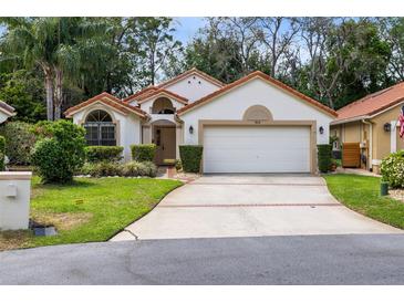 Charming single-story home with a two-car garage, well-maintained landscaping, and a welcoming facade at 912 Augusta National Blvd, Winter Springs, FL 32708