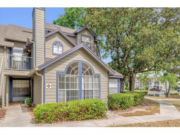 Charming townhome featuring a unique arched window and neat landscaping for enhanced curb appeal at 948 Bird Bay Ct # 102, Lake Mary, FL 32746