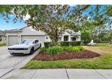 Charming single-story home with a well-maintained front yard and a two-car garage at 955 Holly Springs Ter, Oviedo, FL 32765