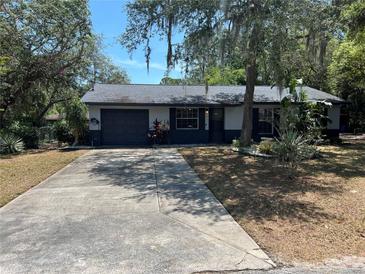 Charming single-story home featuring a spacious driveway and well-maintained landscaping at 261 Deleon Rd, Debary, FL 32713