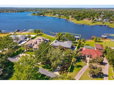 Aerial shot of estate home showcasing lake access and mature landscaping at 2828 Marquesas Ct, Windermere, FL 34786