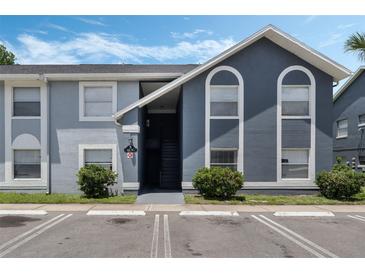 Inviting condo exterior features a well-maintained facade and parking at 4136 Pershing Pointe Pl # 2, Orlando, FL 32822