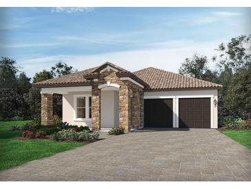 Charming single-story home features a stone facade, tile roof and a two-car garage at 5254 Citrus Leaf Blvd, Winter Garden, FL 34787